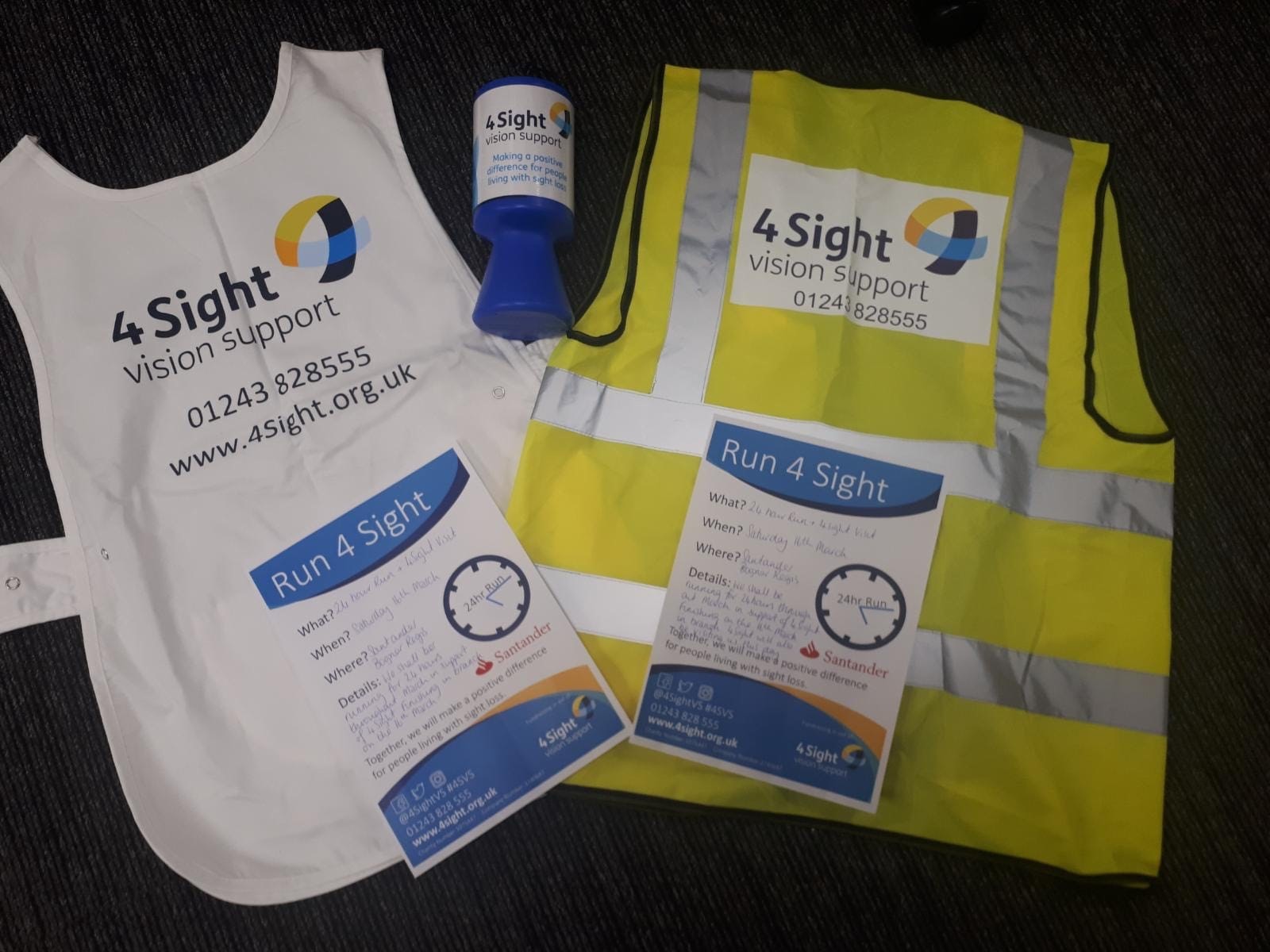 4Sight Vision Supportcharity bib and hi-vis jacket with blue collection can and posters.