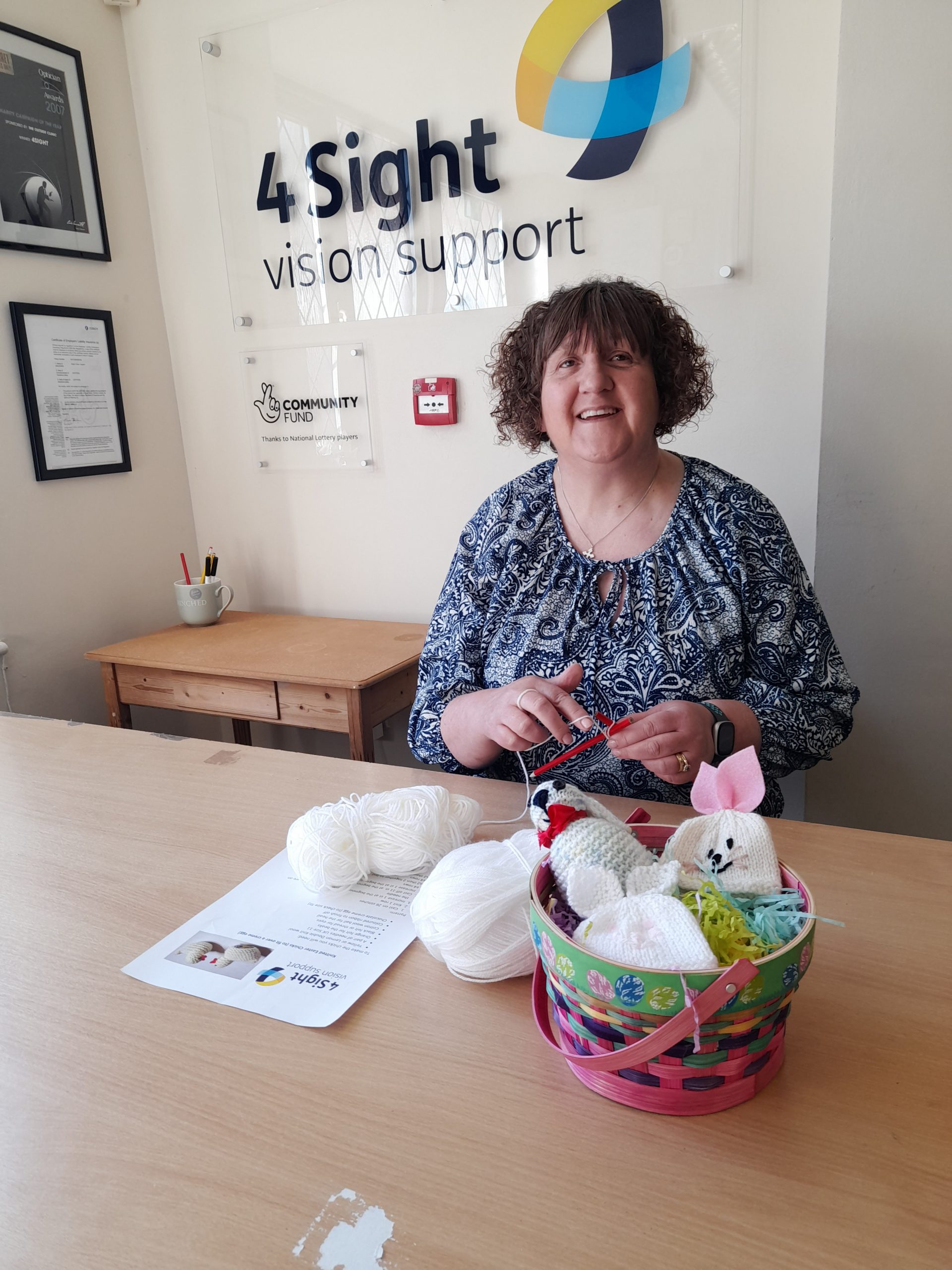 Image: The image shows Volunteer Claire busy knitting Easter novelties.