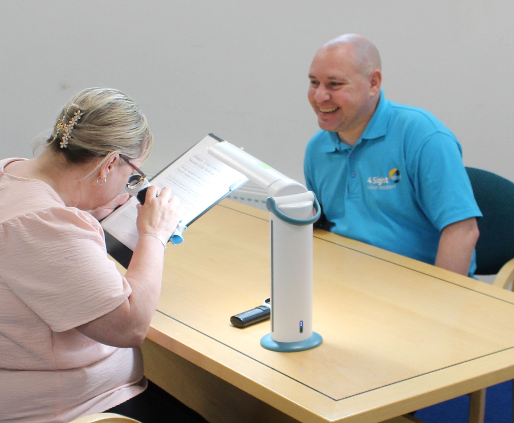 Richard supporting a person with a low vision assessment